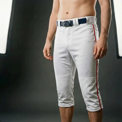 A pair of modern crop-length grey baseball pants with a white contrast pocket and side piping, made from breathable needle eye mesh.
