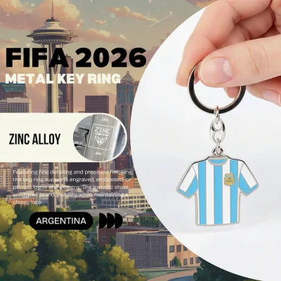 Argentina national football team FIFA 2026 metal key ring, zinc alloy jersey-shaped key chain with Argentine Football Association crest, light blue-white striped soccer jersey design, fine detailing and precision finishing, metallic shine, classy look, FIFA 2026 World Cup fan accessory
