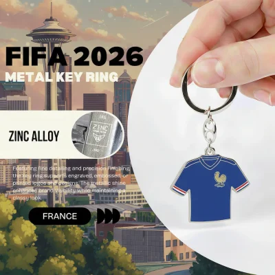 France national football team FIFA 2026 metal key ring, zinc alloy jersey-shaped key chain with French Football Federation rooster crest, blue soccer jersey design with red-white-blue striped cuffs, fine detailing and precision finishing, metallic shine, classy look, FIFA 2026 World Cup fan accessory